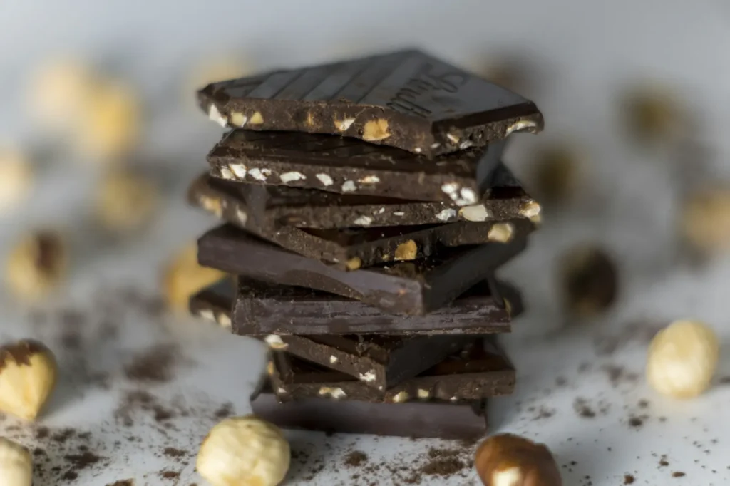 Pile de carrés de chocolat noir aux noisettes